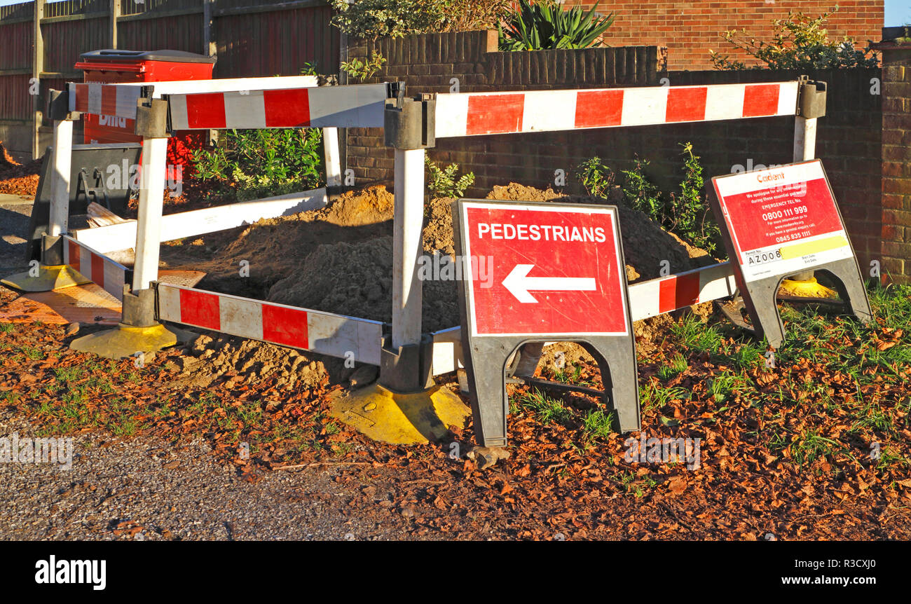 Ein Loch im Boden mit Abschrankungen und Zeichen untersucht einen möglichen Gasaustritt. Stockfoto