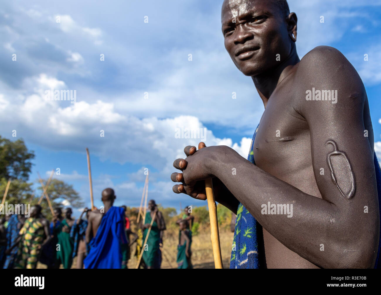 Suri Stamm Krieger mit einem scarification auf dem Arm während eines donga Stockkampf Ritual, Omo Valley, Kibish, Äthiopien Stockfoto