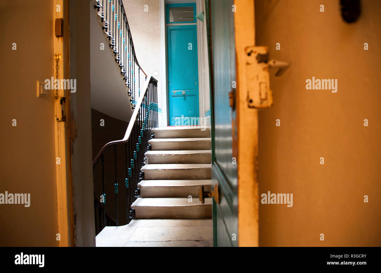 Ansicht der kommunalen Flur und Treppe mit Blue apartment Tür von innen orange flach Stockfoto