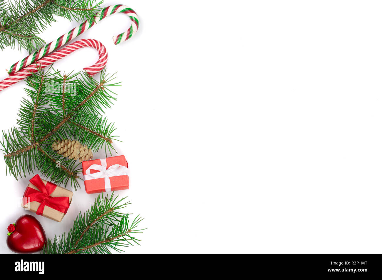Weihnachten Rahmen der Fir Tree Branch mit Zuckerstangen und Boxen auf weißem Hintergrund mit Kopie Platz für Ihren Text isoliert Stockfoto