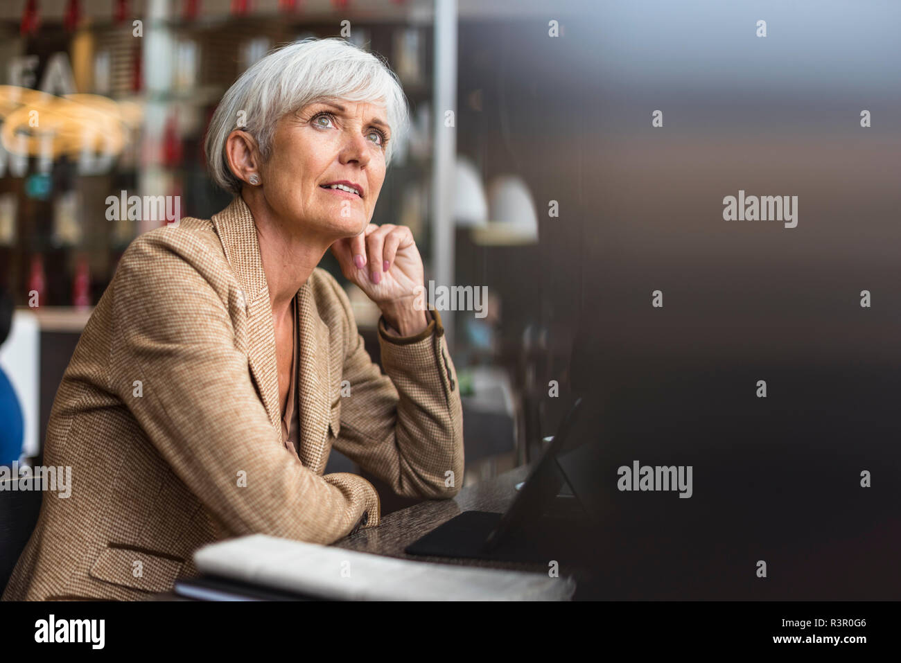 Senior Geschäftsfrau mit Tablette in ein Cafe denken Stockfoto