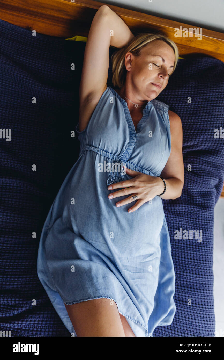 Reifen schwangere Frauen Nickerchen auf dem Bett Stockfoto