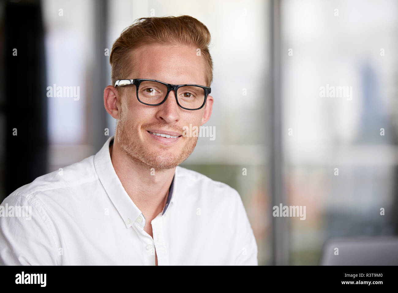 Portrait von lächelnden redheaded Geschäftsmann mit Brille Stockfoto