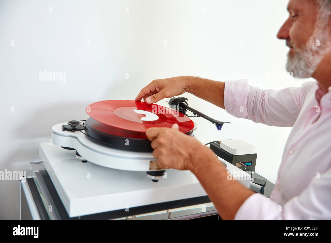 Reifer Mann, roten Vinyl Record auf Plattenspieler Stockfoto