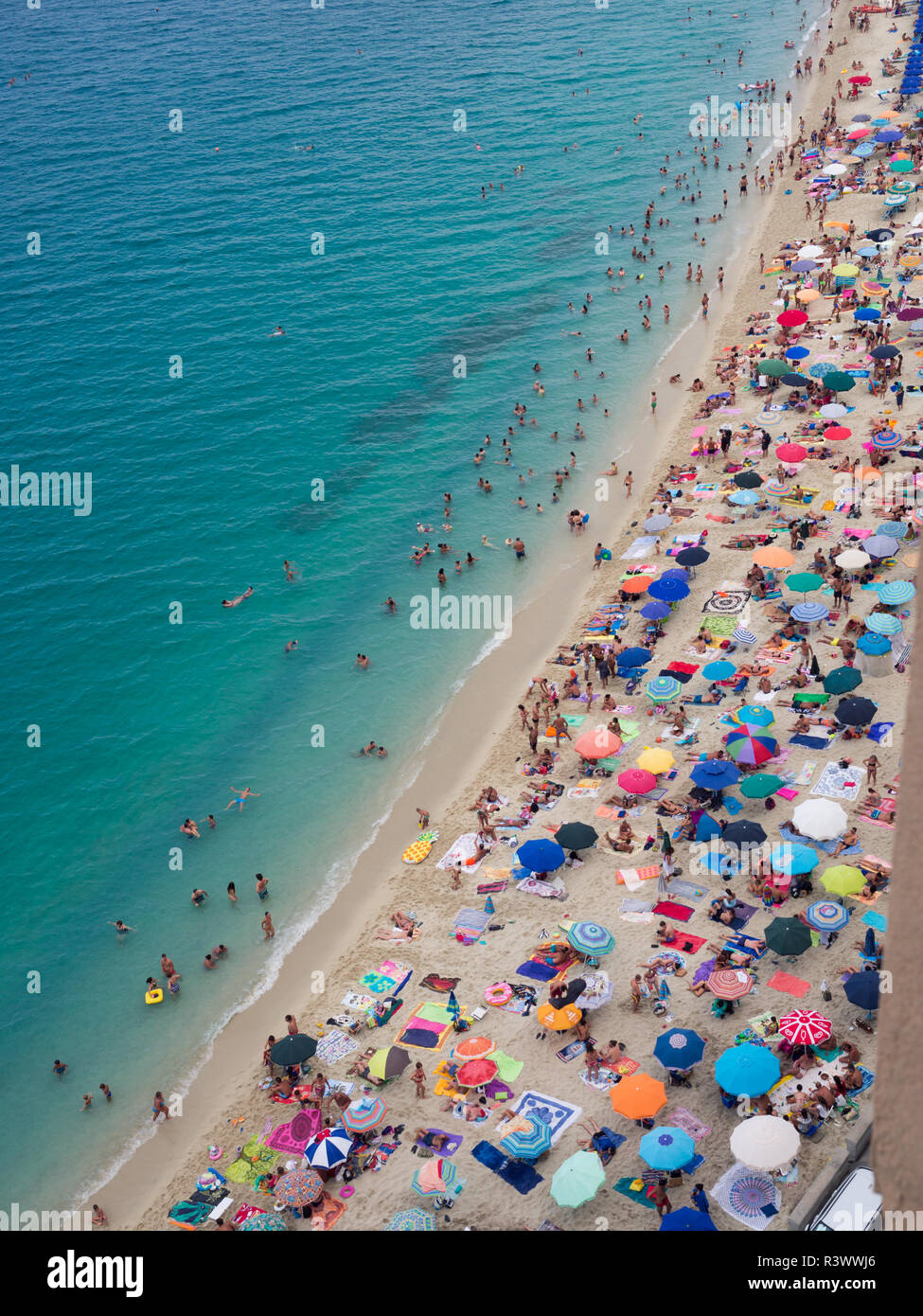 Tropea, Italien - 21 August 2018: Strand mit kristallklarem Meer mit Schwimmer voll. Ansicht von oben. Stockfoto