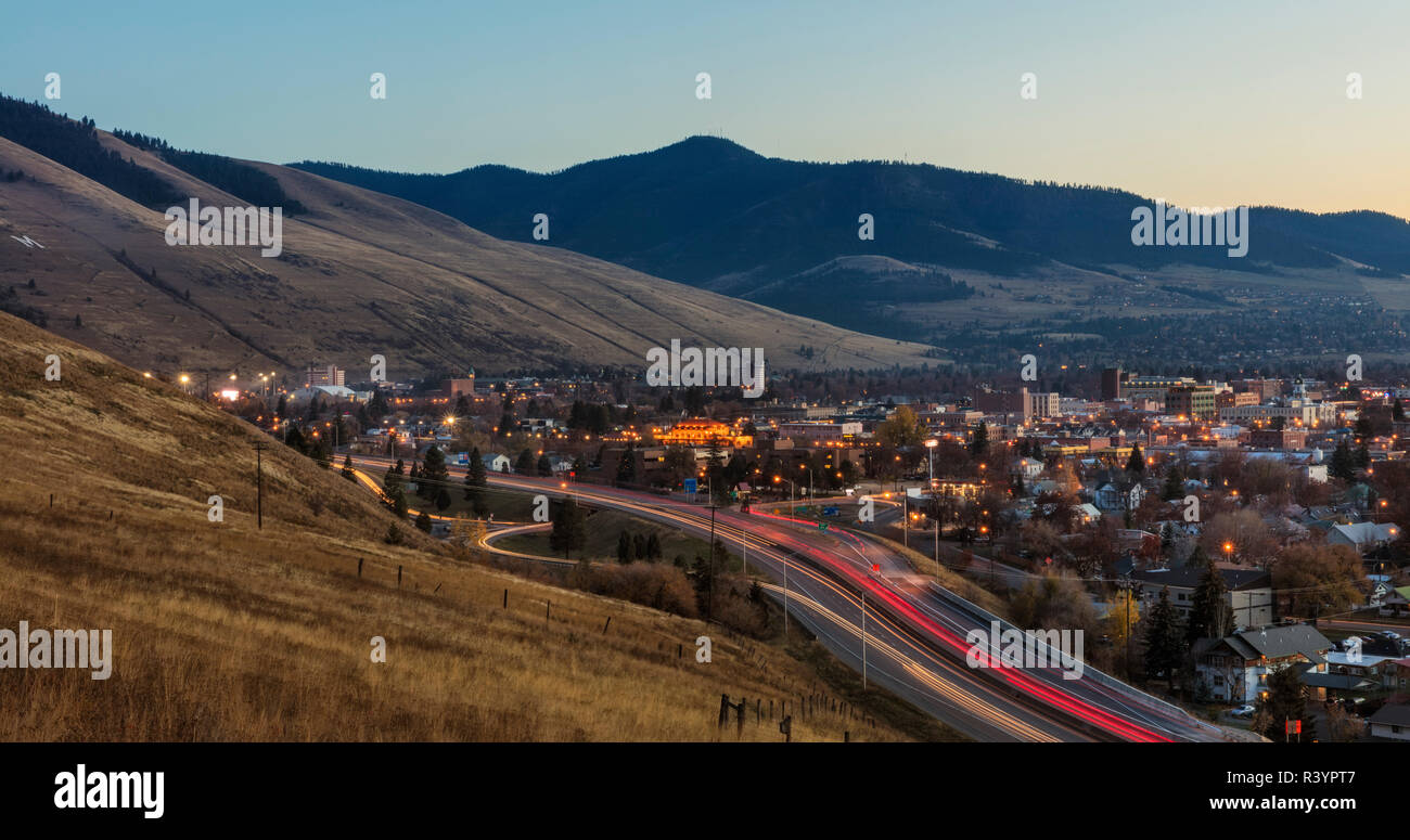 Der Verkehr auf der Interstate 90 fließt durch Missoula, Montana in der Dämmerung Stockfoto