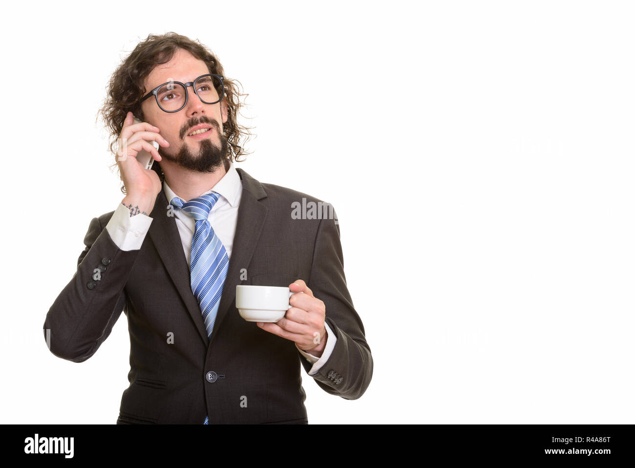 Stattlichen kaukasischen Geschäftsmann Gespräch am Handy und holdi Stockfoto