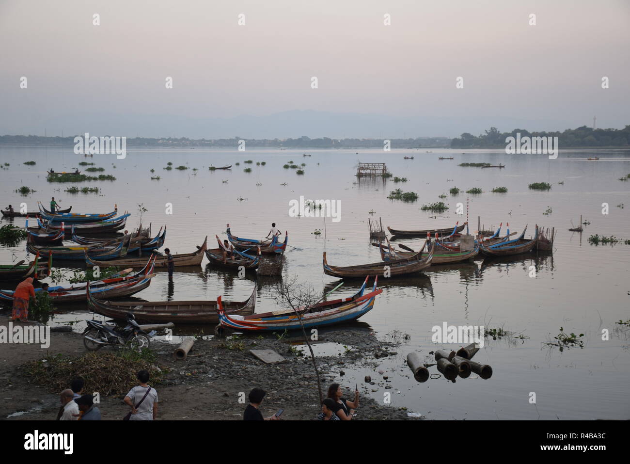 Boote schwimmend auf Taung Tha Mann See von U-Bein bridge bei Sonnenuntergang in Amarapura, Myanmar gesehen Stockfoto