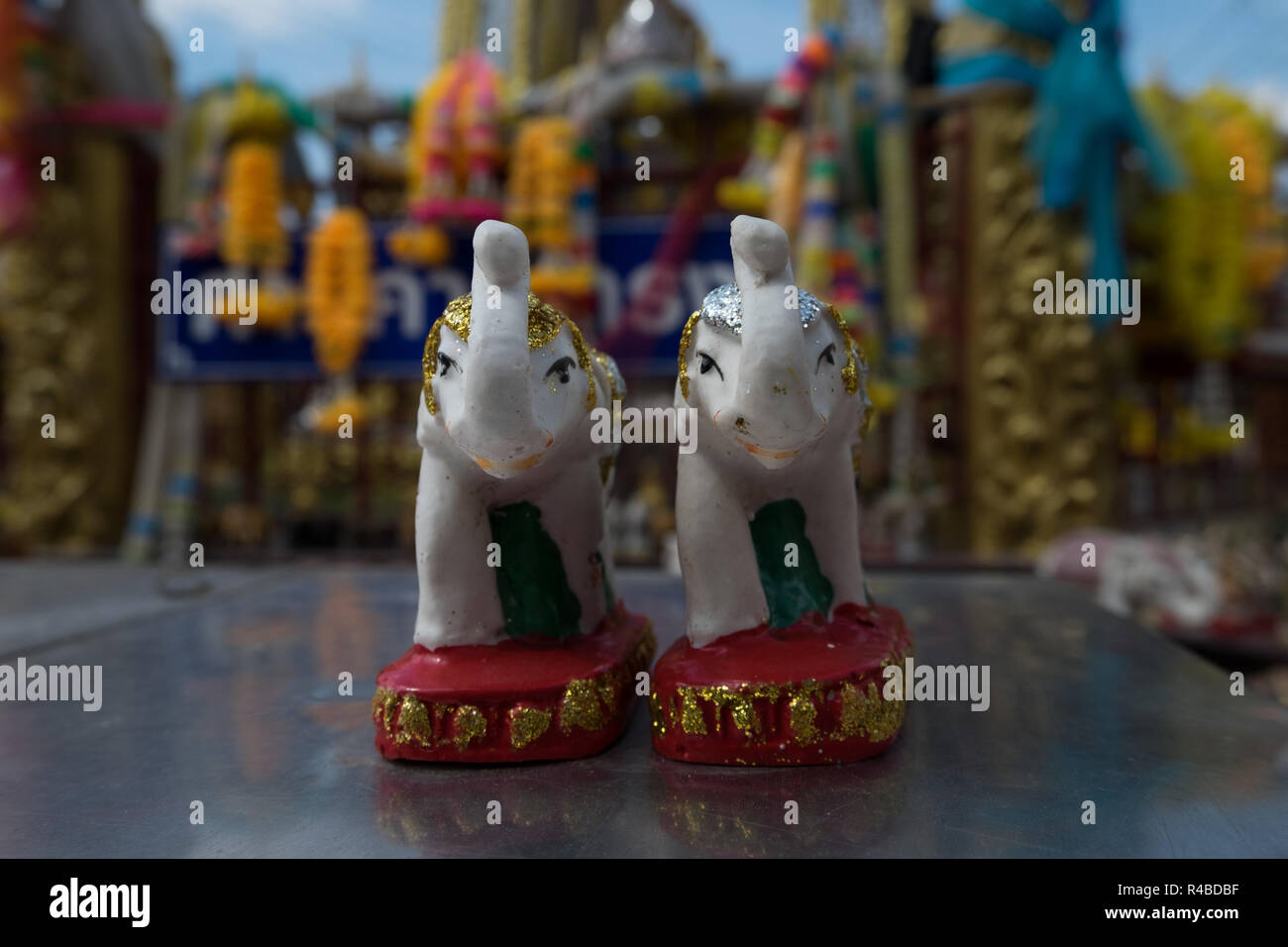 Ein niedliches Paar kleine cermaic Elefanten in Glitter zu einem religiösen Heiligtum in Hat Yai, Thailand geschmückt. Stockfoto