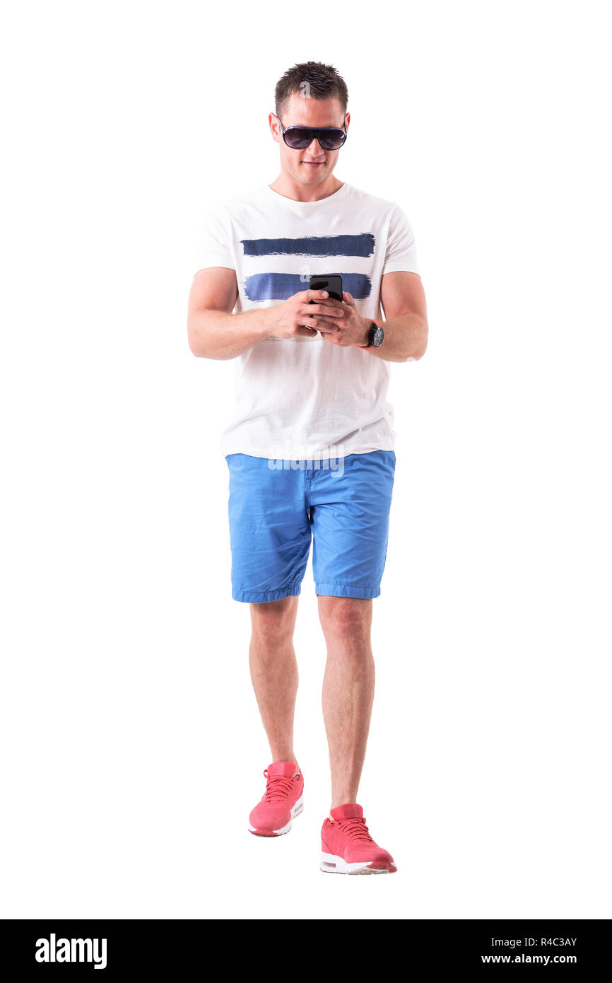 Legerer Mann im Sommer Kleidung Wandern und Surfen im Internet auf dem Smartphone. Voller Körper auf weißem Hintergrund. Stockfoto