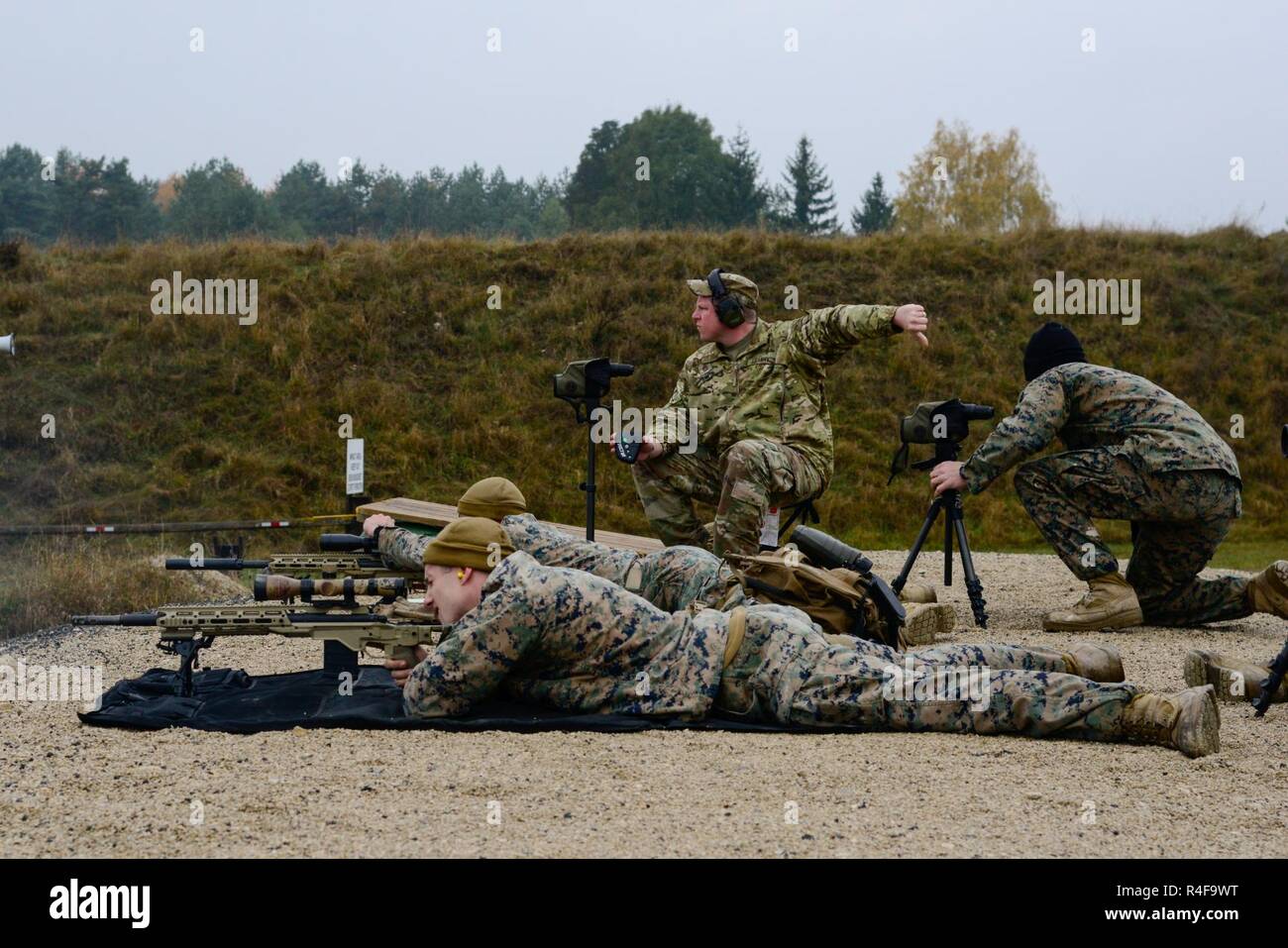 Us-Marines zusammen als Team Ziele zu engagieren, während sie durch ein US-Soldat, der 173Rd Airborne Brigade zugewiesen, während die Besten Europäischen Sniper Squad Konkurrenz an der 7th Army Training Befehl Grafenwöhr Training Area, Deutschland, Okt. 24, 2016 7/2. Die Europäische beste Sniper Squad-Wettbewerb ist eine Armee Europa Konkurrenz, anspruchsvolle Militärs aus ganz Europa zu konkurrieren und die Zusammenarbeit mit Verbündeten und Partner Nationen verbessern. Stockfoto