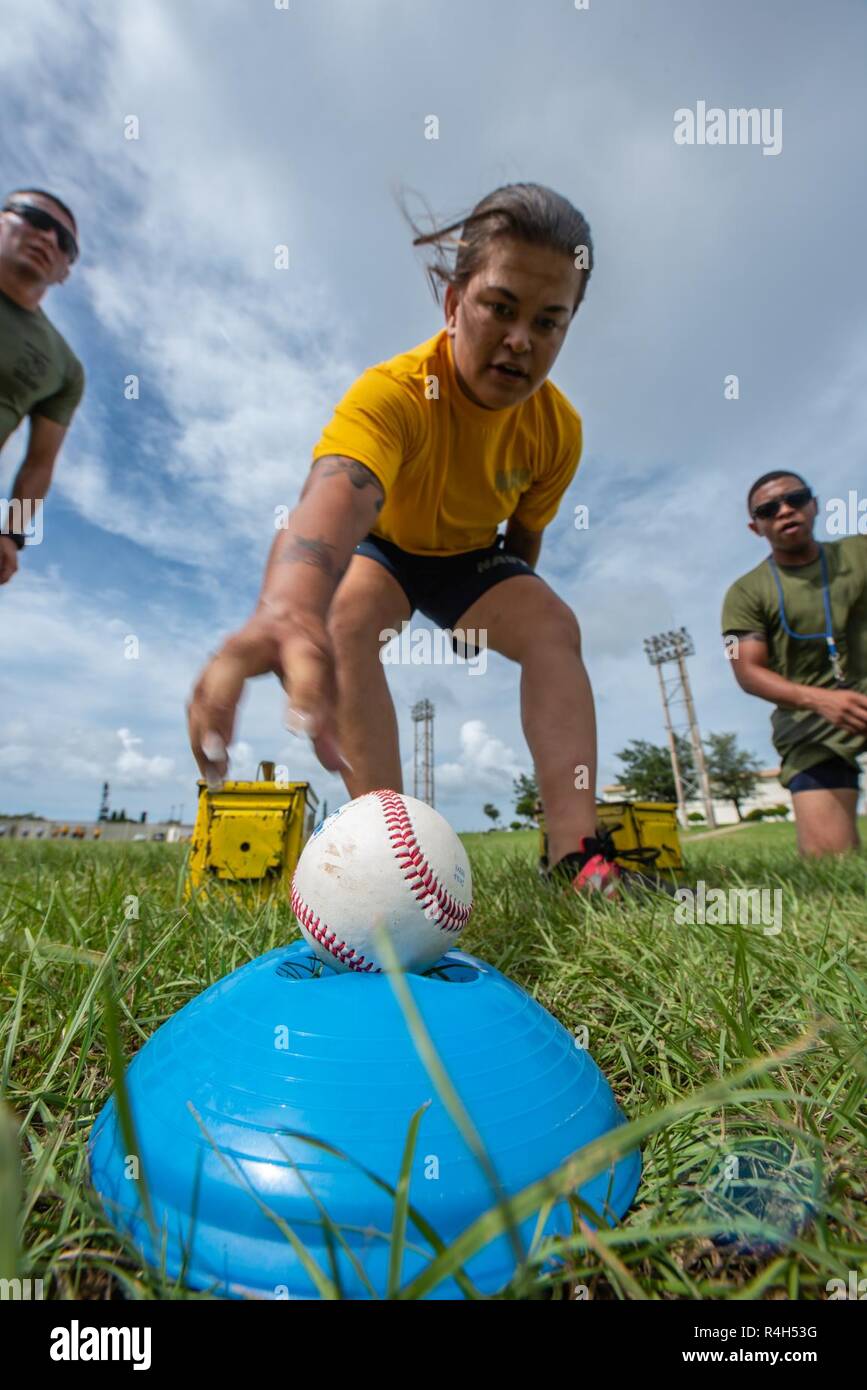 U.S. Navy Petty Officer 3rd Class Emily Pall, Okinawa gemeinsame Erfahrung Green Team Student, Reichweiten für einen Baseball während der Okinawa gemeinsame Fitness Herausforderung Sept. 26, 2018, bei Kadena Air Base, Japan. Während die Herausforderung, waren die baseballs verwendet Granaten zu simulieren. Teams wurden abgezogen Punkte auf die Genauigkeit Ihrer wirft. Stockfoto