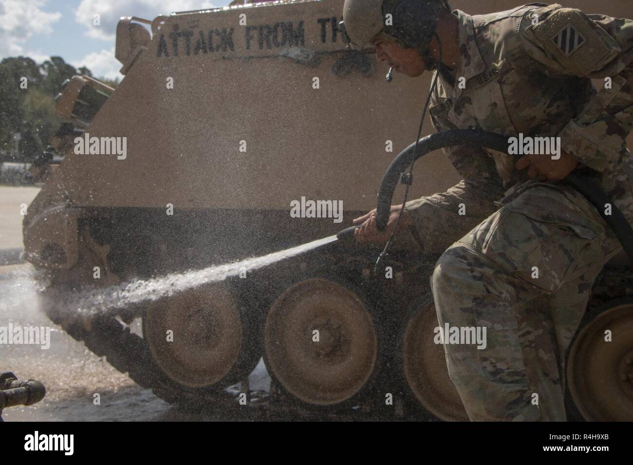 Spc. Dunson Darious an 2nd Battalion, 69th Armored Regiment, 2. gepanzerte Brigade Combat Team, reinigt die Tracks auf seine zugewiesene M113 Schützenpanzer in Fort Stewart, Ga., Okt. 3, 2018. Soldaten, saubere Fahrzeuge als Teil der regelmäßigen Wartung und Pflege der Ausrüstung. Stockfoto