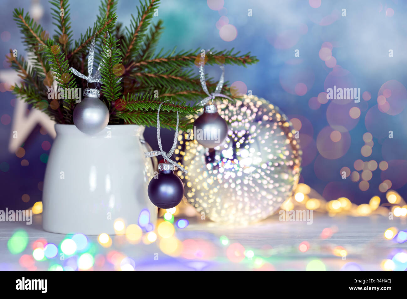 Winter Urlaub Dekorationen mit grünen Tannenbaum Äste, Weihnachtskugeln und leuchtenden Weihnachtslichter Stockfoto