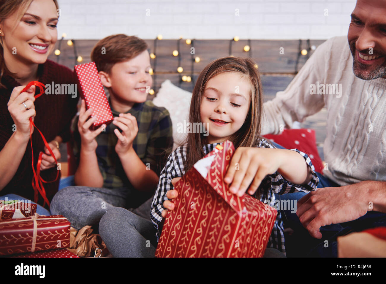 Kinder Eröffnung Weihnachten mit den Eltern vorhanden Stockfoto