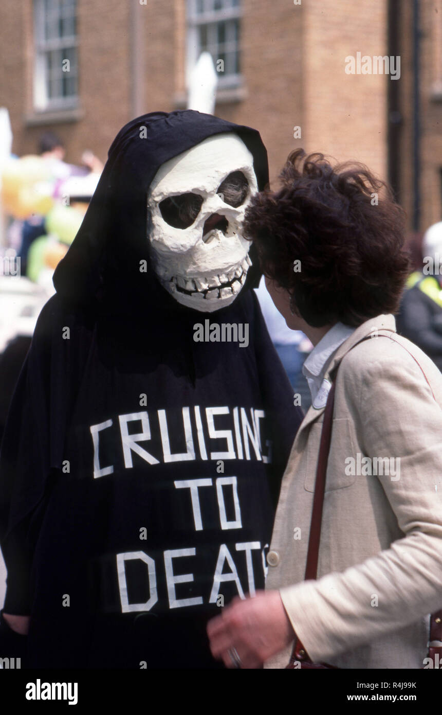 Demonstration von Atomkraftgegnern im London der 1980er-Jahre mit demonstrant trug einen Totenkopf Maske und Uhr, liest Kreuzfahrt zum Tod Stockfoto