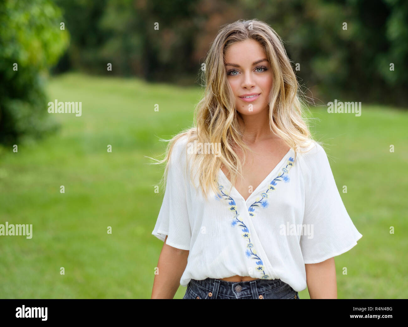 Porträt der jungen Frau im floralen Muster Bluse Stockfoto