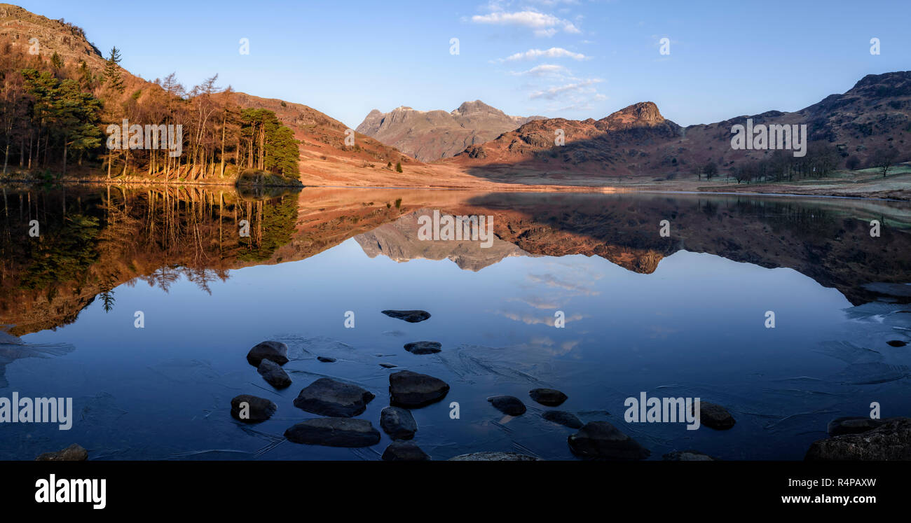 Spiegel - wie Reflexionen der Langdale Pikes in Blea Tarn auf Morgen eine kalte, klare Winter Stockfoto