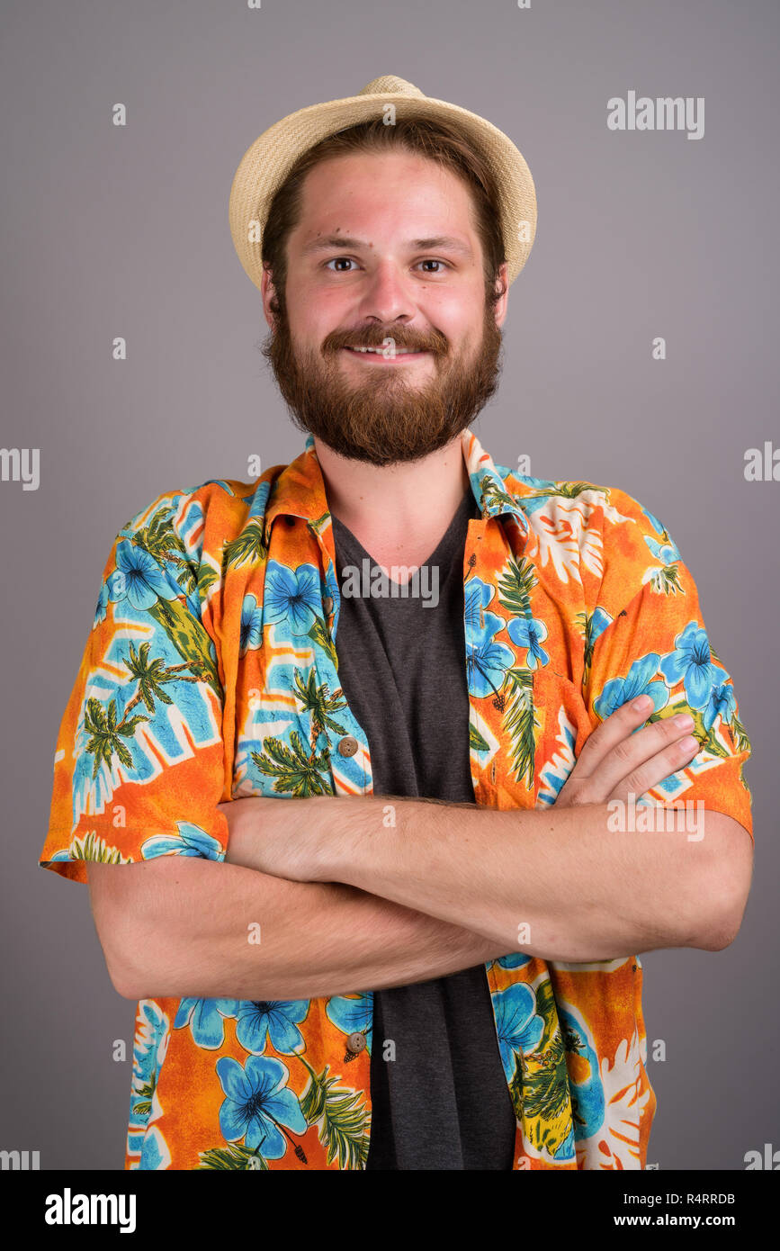 Junge Bartgeier touristische Mann bereit für Ferienhäuser gegen Grau backgr Stockfoto