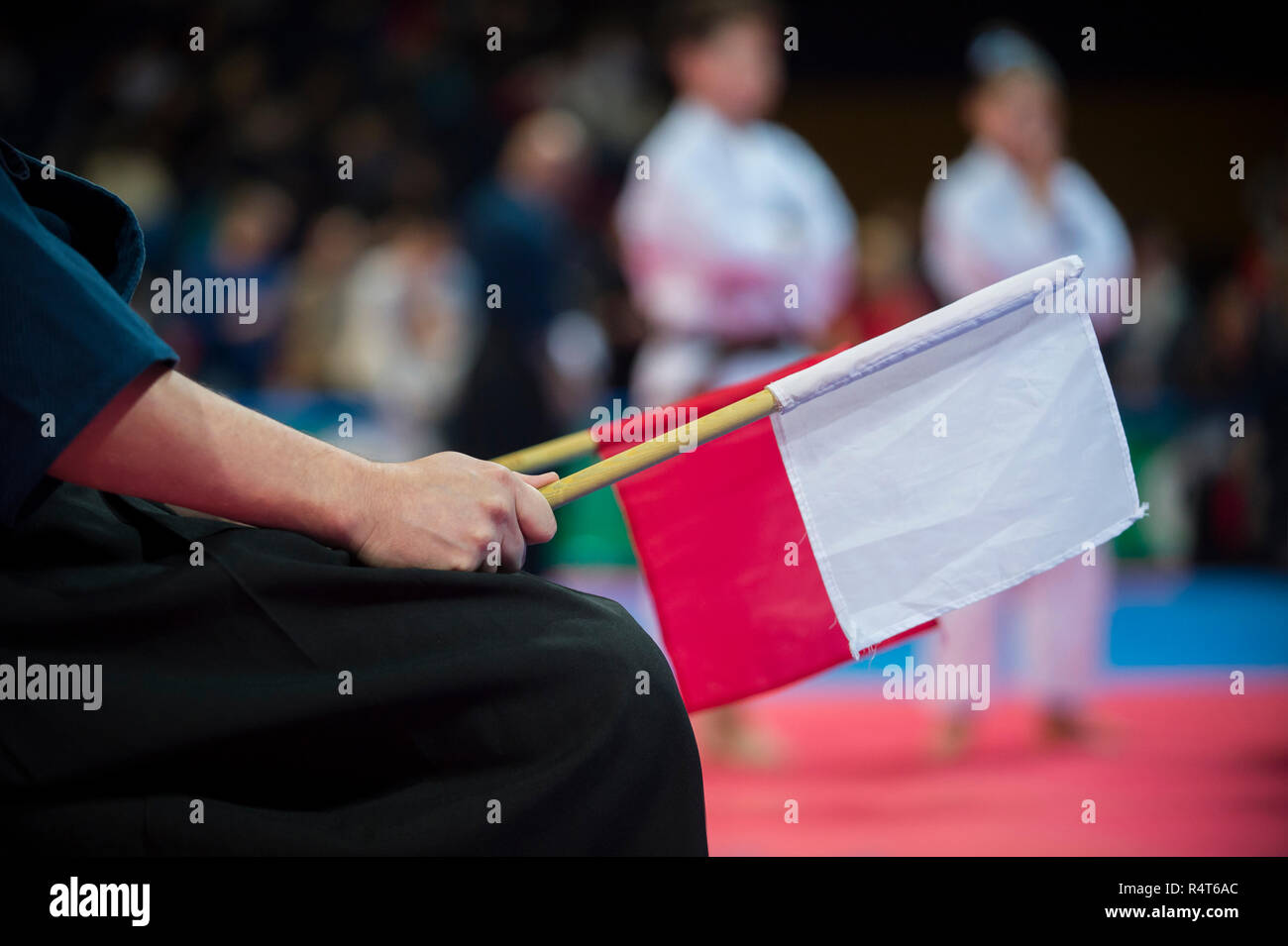 Karate Referee mit rot-weißen Fahnen Stockfoto