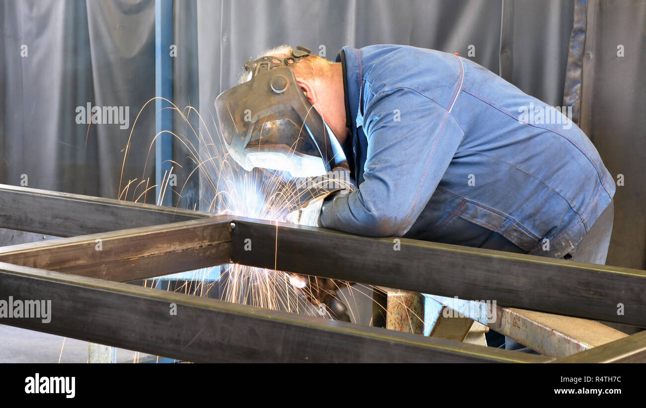 Schweißer arbeitet in Metall Bau - Bau- und Verarbeitung von Stahl Komponenten Stockfoto