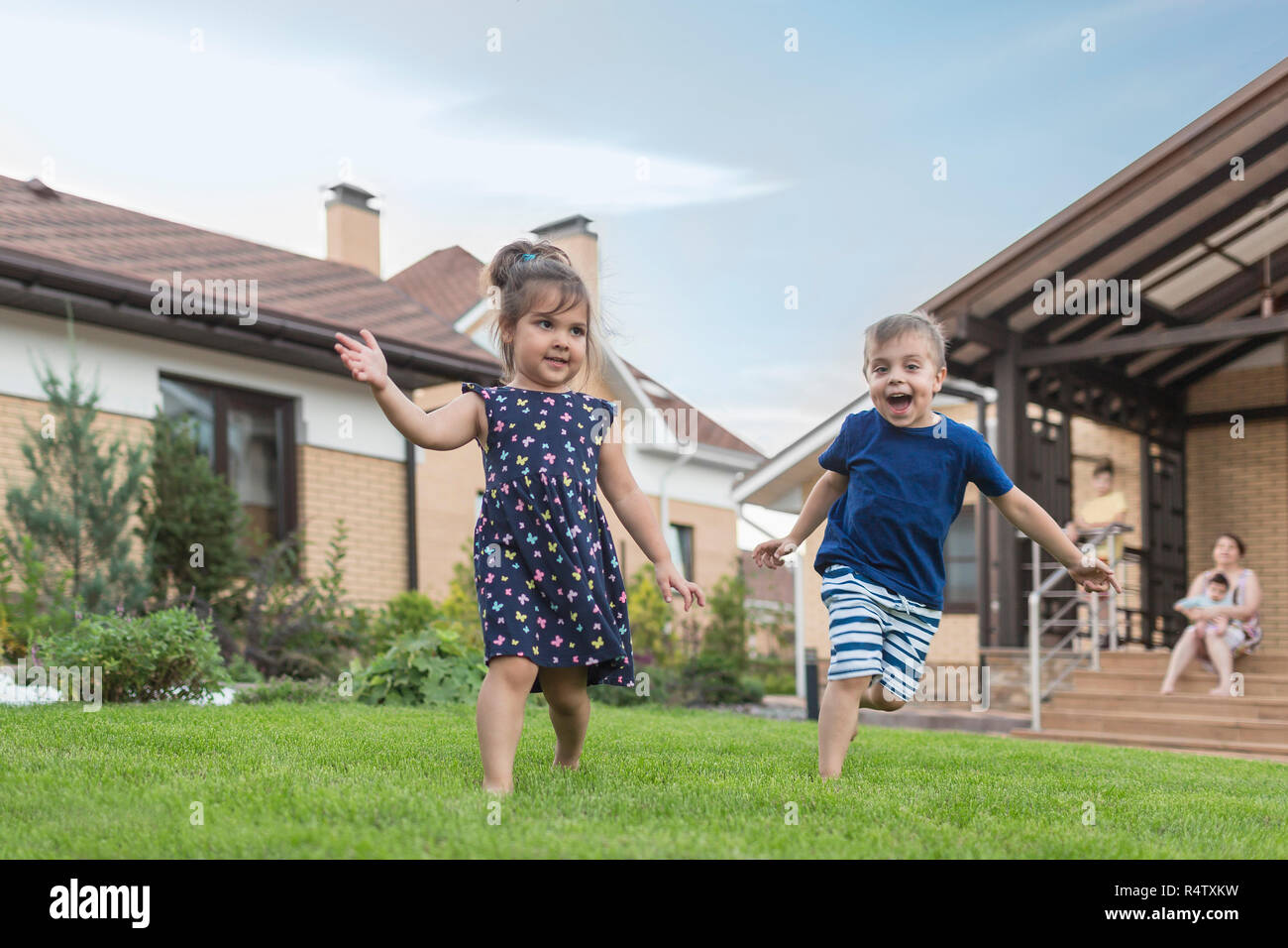 Bruder und Schwester läuft, spielen in den Hinterhof Gras Stockfoto