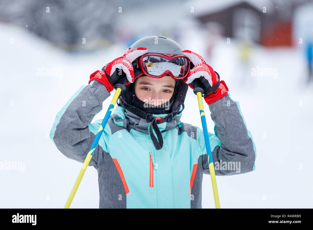 Jugendmädchen in Helm auf dem Berghang bei Ski Resort Stockfoto