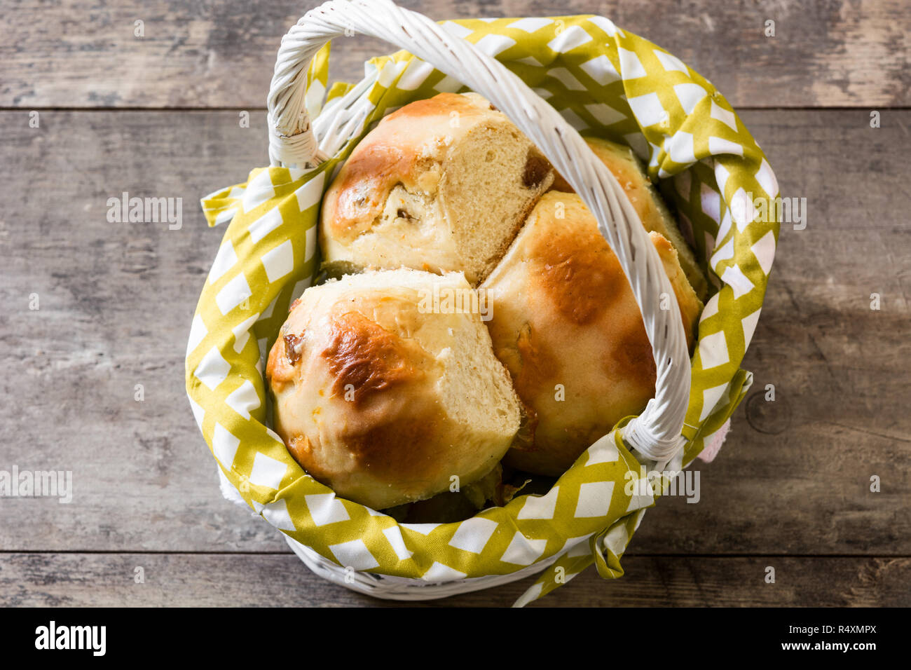 Schöne traditionelle Ostern Hot Cross Buns in einem Korb auf hölzernen Tisch Stockfoto Schöne traditionelle Ostern Hot Cross Buns in einem Korb auf hölzernen Tisch Stockfoto
