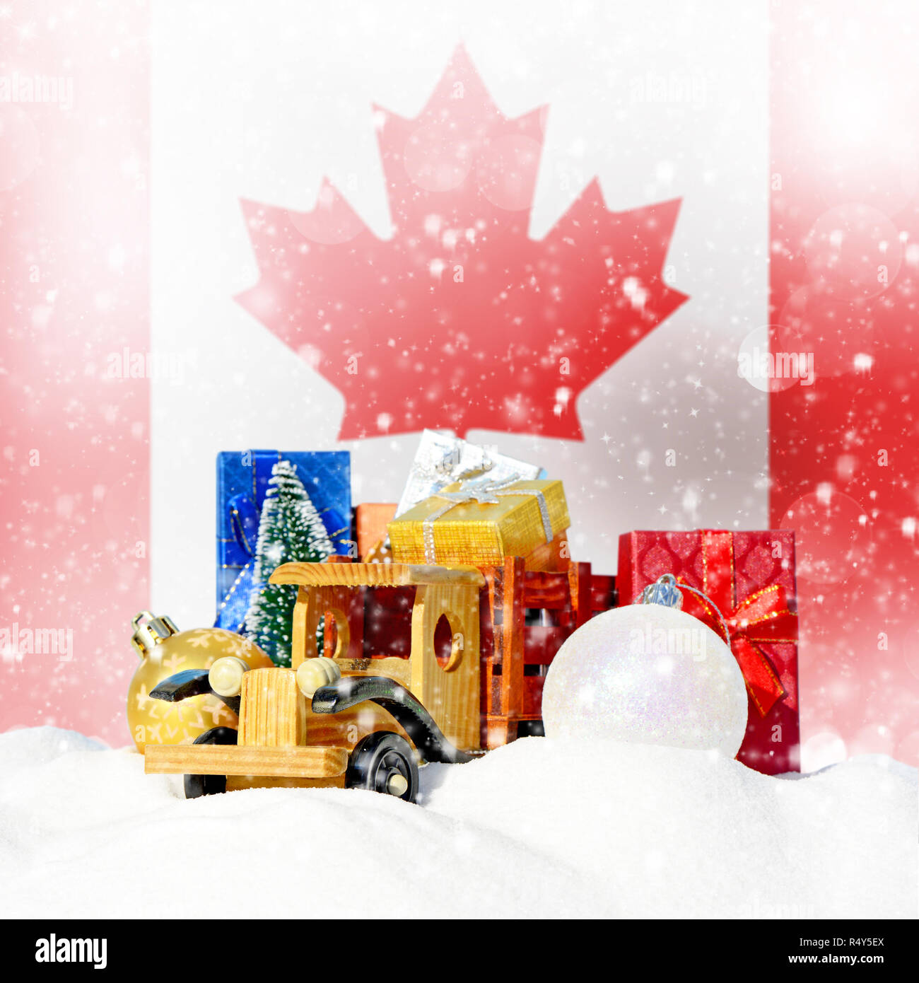 Weihnachten Hintergrund. Spielzeug-LKW mit Geschenken, Neues Jahr Tanne, Kugeln im Schneetreiben und Kanadischen Flagge Stockfoto