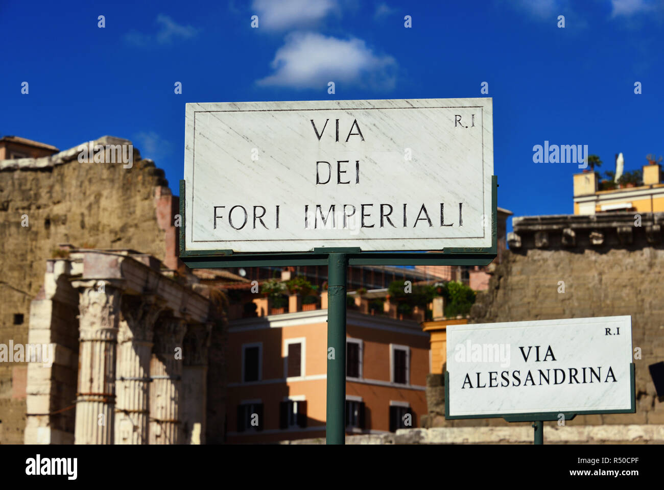 Imperial Fora Avenue und Alessandrina Straße alte Marmor Schild mit antiken Ruinen Hintergrund in Rom Stockfoto