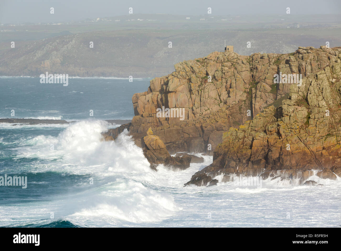 Wellen über pedn Men Du in der Nähe von Sennen Cove in Cornwall. Stockfoto