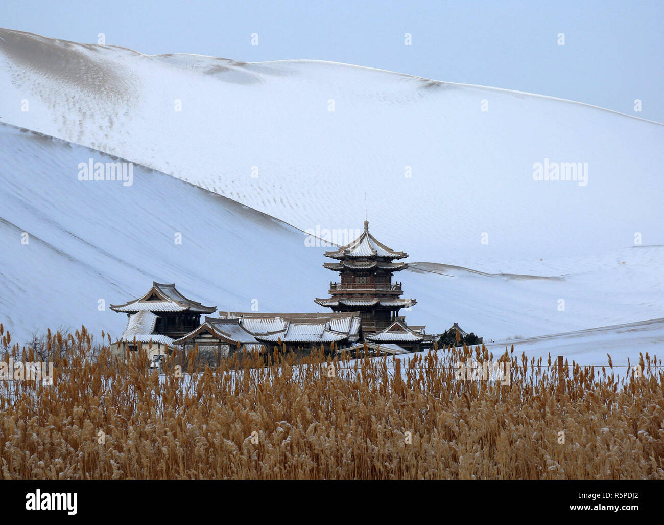 Dunhuang. 2. Dez, 2018. Foto aufgenommen am Dez. 2, 2018 zeigt die Schnee-mingsha Berg und Crescent Feder scenic Spot in Dunhuang, im Nordwesten der chinesischen Provinz Gansu. Schnee ist auf den malerischen Ort gefallen und machte es attraktiver. Credit: Zhang Xiaoliang/Xinhua/Alamy leben Nachrichten Stockfoto