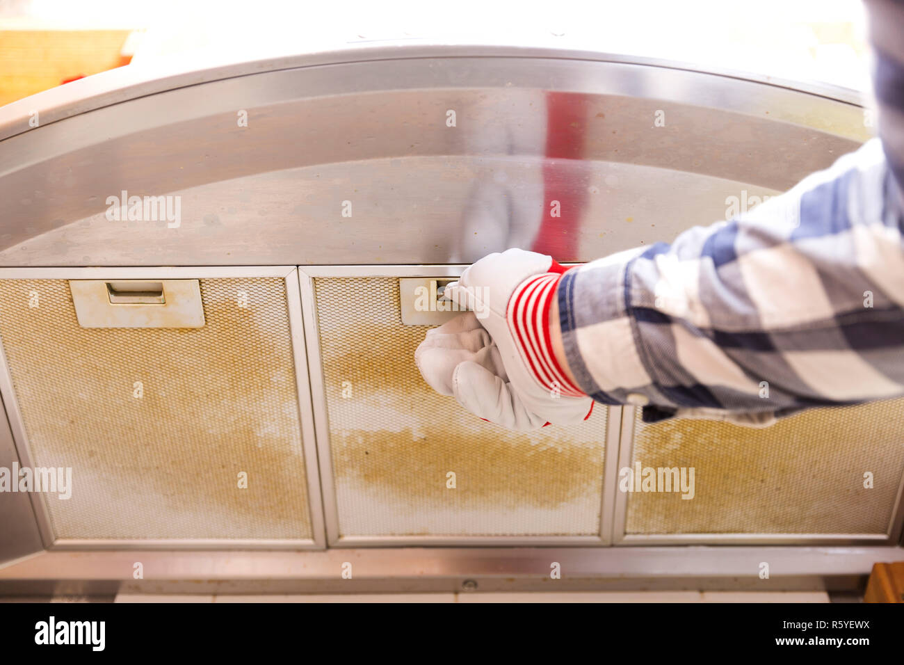 Handwerker, die dreckig Aluminium-mesh-Filter aus der Dunstabzugshaube Stockfoto