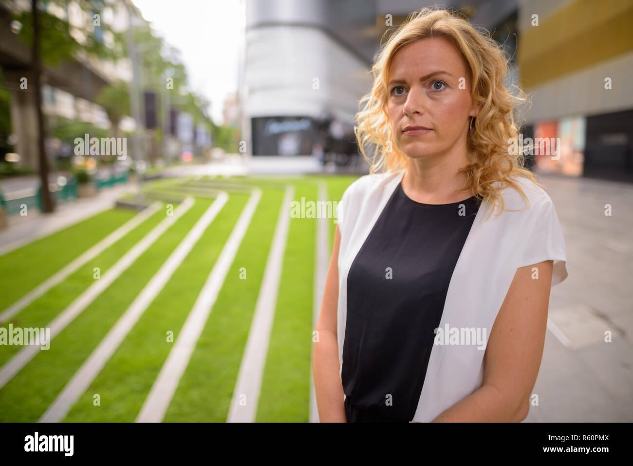 Porträt der schönen blonden Geschäftsfrau Denken im Freien Stockfoto