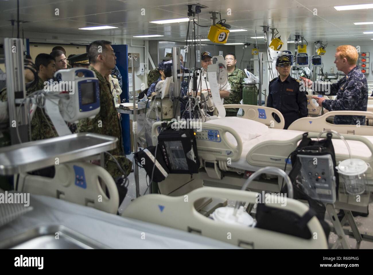 SASEBO, Japan (27. April 2017) Kapitän Kurt Eichenmuller, rechts, aus San Diego, der leitende medizinische Offizier an Bord der Amphibisches Schiff USS BONHOMME RICHARD (LHD6), bietet eine Tour durch intensive care unit des Schiffes an die Mitglieder der japanischen Verteidigung-kraft (JSDF) als Teil einer einweisungsrundgang für die JSDF auf amphibische Fähigkeit. Bonhomme Richard und andere Schiffe und Einheiten der Kommandant, Amphibious Force 7 Flotte, routinemäßig Partner mit der JSDF das gegenseitige Verständnis und die Interoperabilität zu erhöhen die US-japanischen Allianz weiter zu stärken. Stockfoto