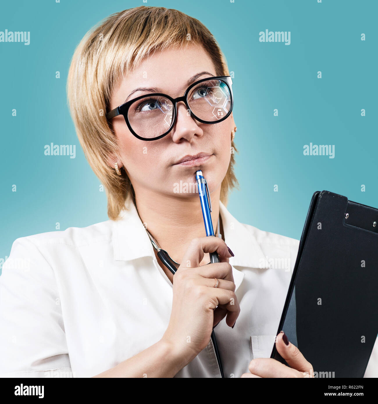 Nachdenklich Arzt Frau hält die Zwischenablage und oben zu schauen. Stockfoto