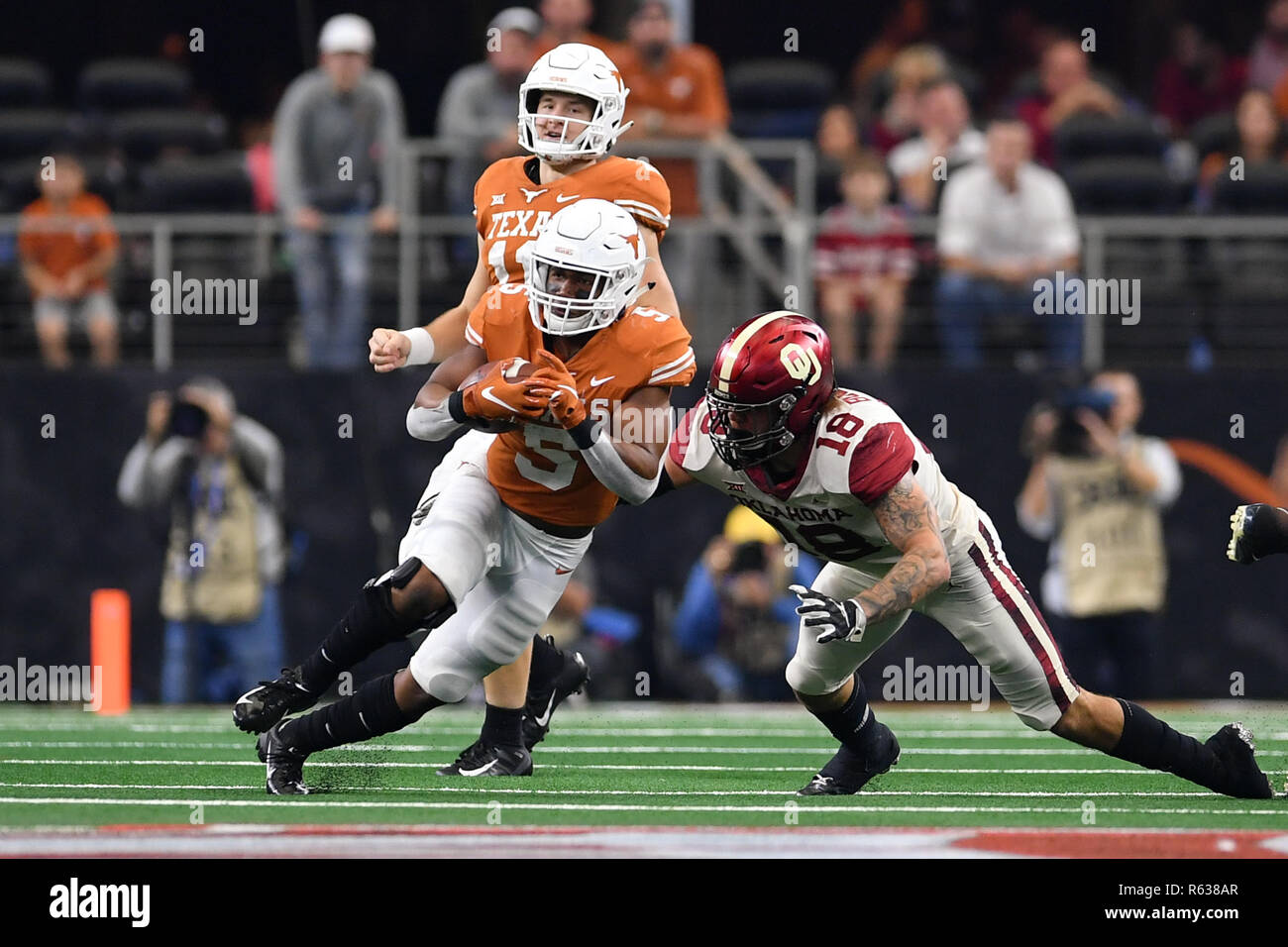 Arlington, Texas, USA. 1. Dez, 2018. Oklahoma Sooners linebacker Curtis Bolton (18) versucht, die Texas Longhorns zurück laufen Tre Watson (5) während der zweiten Hälfte der grossen Meisterschaft 12 NCAA Football Spiel zwischen der Universität von Texas und an die Universität von Oklahoma Sooners bei AT&T Stadium in Arlington, Texas. Oklahoma Sooners Niederlage Texas Longhorns 39-27. Shane Roper/CSM/Alamy leben Nachrichten Stockfoto