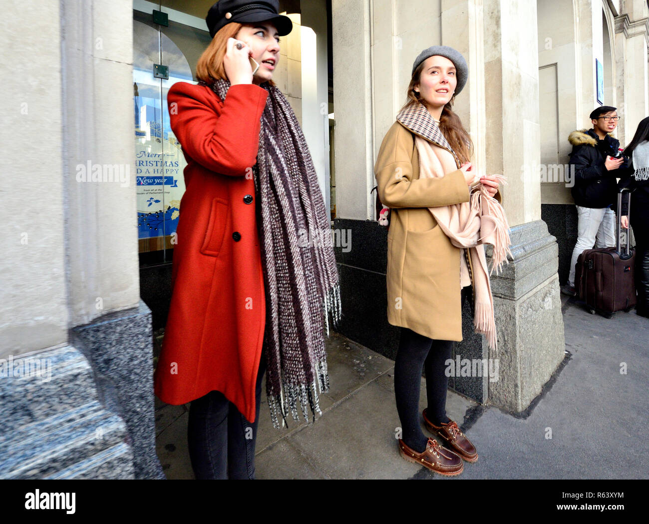Junge Frau mit ihrem Handy in Parliament Square, London, England, UK. Stockfoto