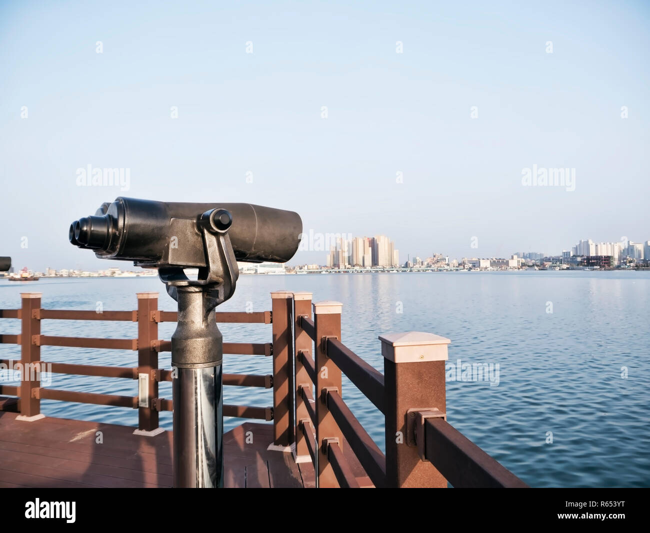 Beobachtung Ferngläser auf dem Pier und Sokcho City auf dem Hintergrund, Südkorea Stockfoto