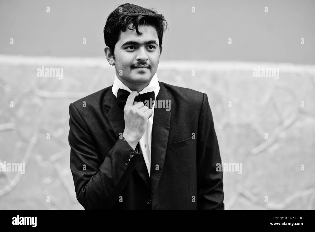 Junge Inder auf schwarzen Anzug und Fliege stellte Outdoor. Stockfoto