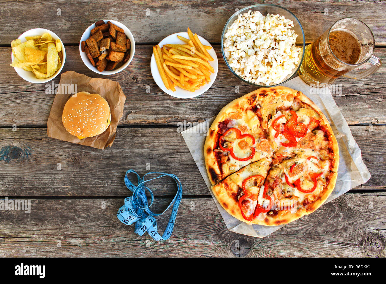 Fast food, Maßband auf alten Holz- Hintergrund. Konzept der Junk-Essen. Getönten Bild. Ansicht von oben. Stockfoto