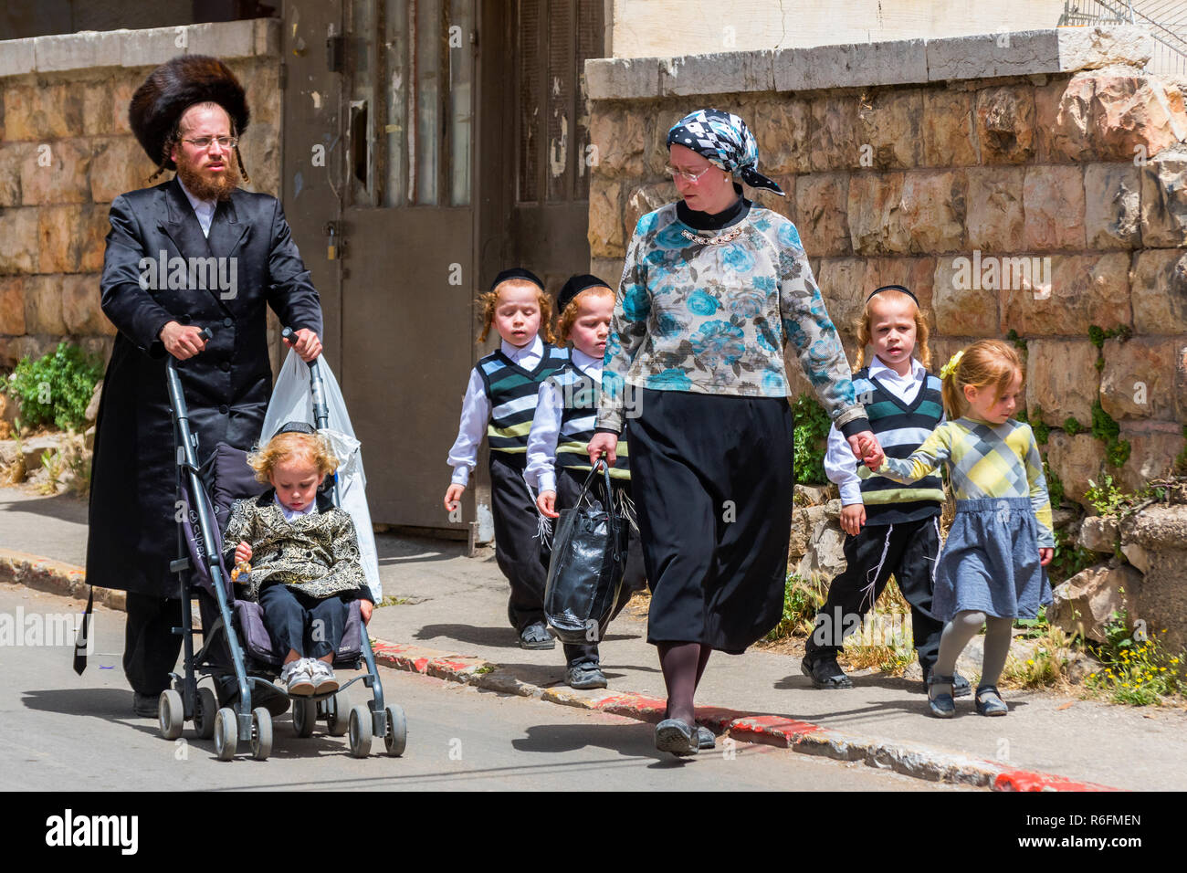 Einen traditionellen orthodoxen jüdischen Familie mit dem Kind auf der Mea Shearin Straße in Jerusalem, Israel Stockfoto