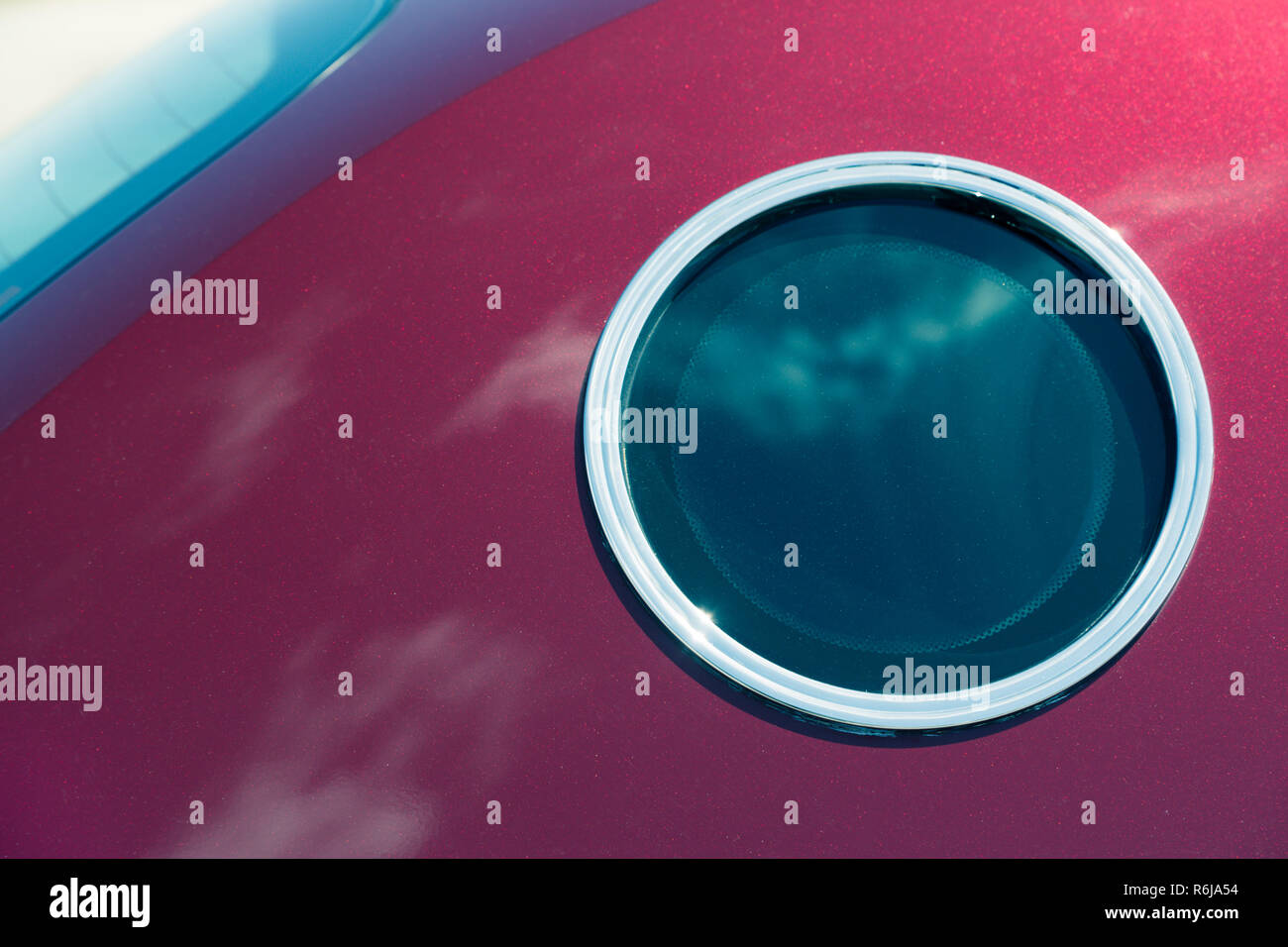 Runde Fenster ähnlich wie ein Bullauge in Crimson Auto Stockfoto