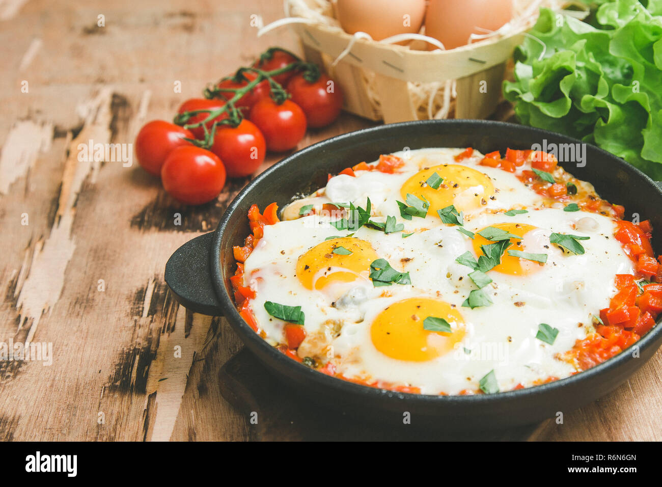 Lecker und gesund Shakshuka in der Pfanne. Spiegeleier mit Tomaten ...