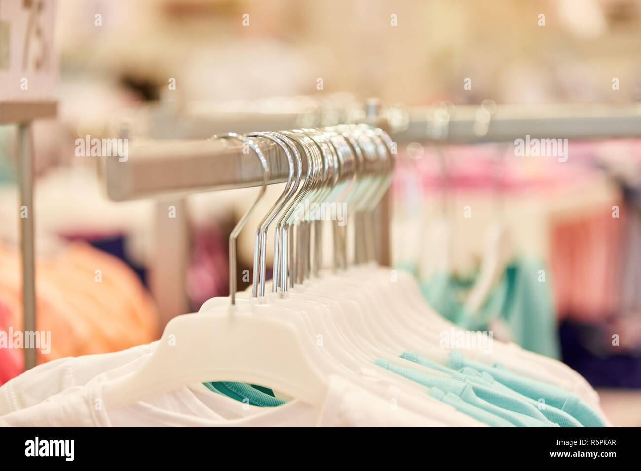 Kleider auf Kleiderbügeln in einem fashion Discounter oder Boutique Stockfoto