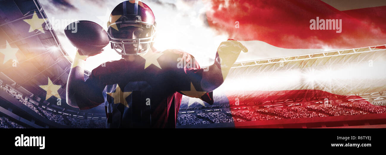 American Football Spieler mit Helm Vorbereitung Kugel gegen in der Nähe von Werfen, eine amerikanische Flagge Stockfoto
