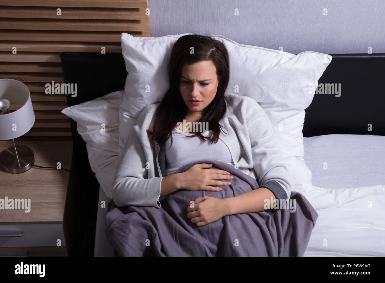 Hohe Betrachtungswinkel und einer Frau mit Magenschmerzen Stockfoto