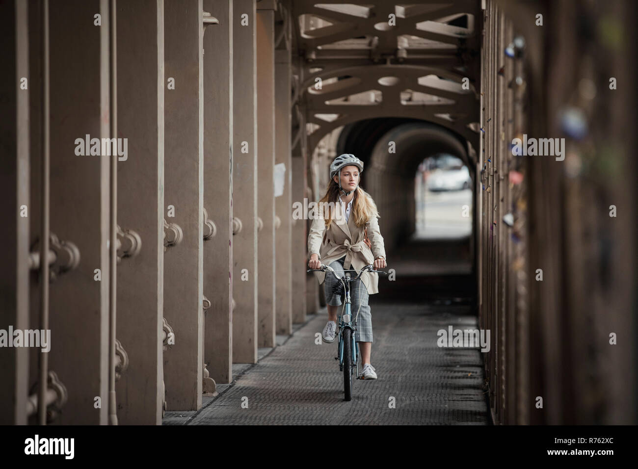 Junge weibliche Erwachsene Radfahren über eine Brücke Stockfoto