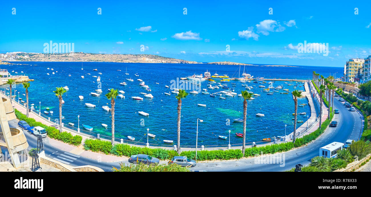 Blick auf den Fischerhafen von Resort vom Hügel, hohen Palmen erstrecken sich entlang der Dawret Il-Gzejjer Strandpromenade, zahlreiche kleine Boote ein Stockfoto