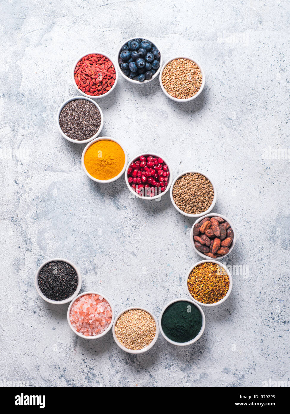 Schreiben der Superfoods in Schüssel auf blauem Hintergrund Stockfoto